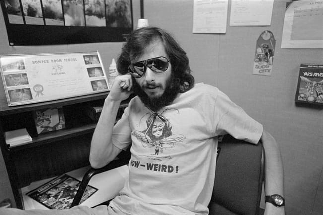 Howard Scott Warshaw in weird t-shirt, sitting at desk